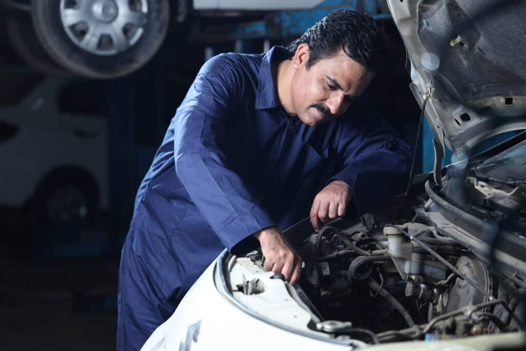 Mechanic working on a car in a garage
